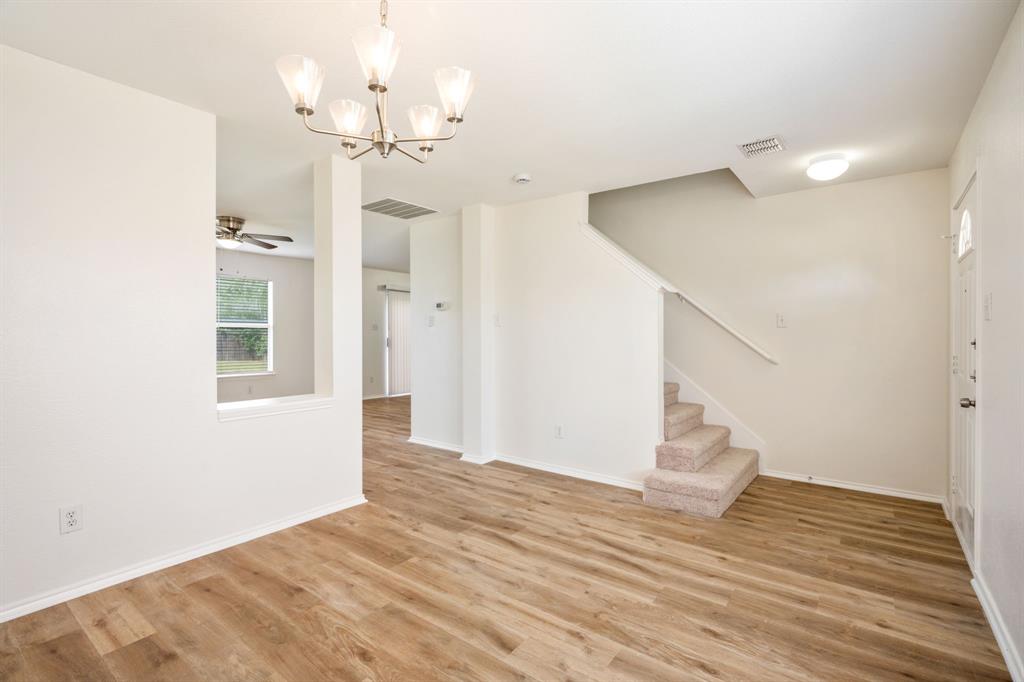 1626 White Oak Road Anna, TX 75409 - Photo 12 of 30 a view of empty room with wooden floor and ceiling fan