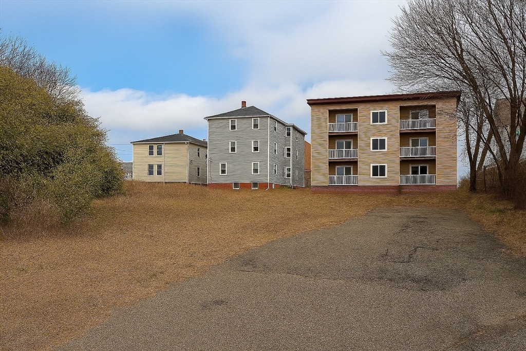 1 Arlington Street Worcester, MA 01604 - Photo 1 of 7 a large house with a large parking space and large trees