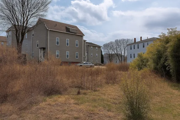 an aerial view of residential houses with outdoor space