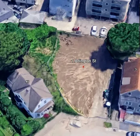 an aerial view of a house with a yard and garden