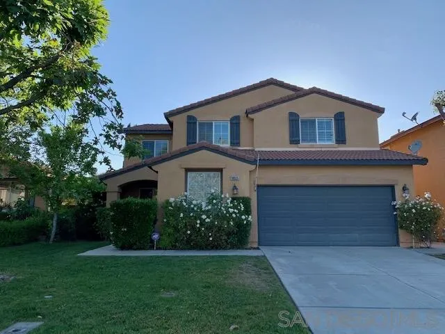 38325 Encanto Road Murrieta, CA 92563 - Photo 1 of 17 a front view of a house with a yard and garage