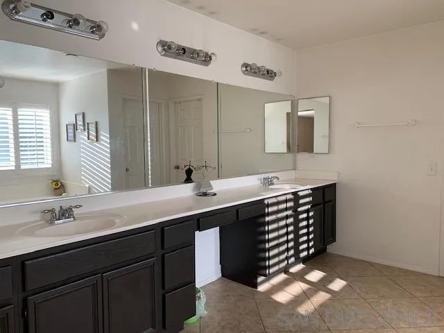 38325 Encanto Road Murrieta, CA 92563 - Photo 12 of 17 a bathroom with a sink double vanity and a mirror