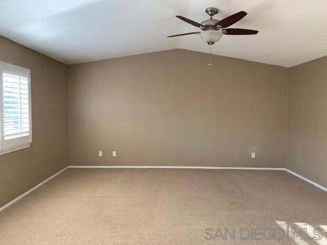 38325 Encanto Road Murrieta, CA 92563 - Photo 15 of 17 an empty room with a window and a ceiling fan