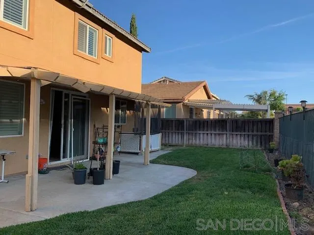 38325 Encanto Road Murrieta, CA 92563 - Photo 17 of 17 a view of a house with brick walls and a yard with plants