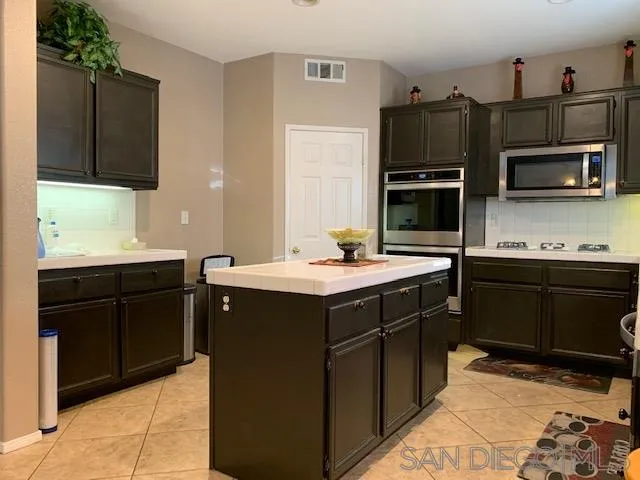 38325 Encanto Road Murrieta, CA 92563 - Photo 5 of 17 a kitchen with a sink and steel appliances