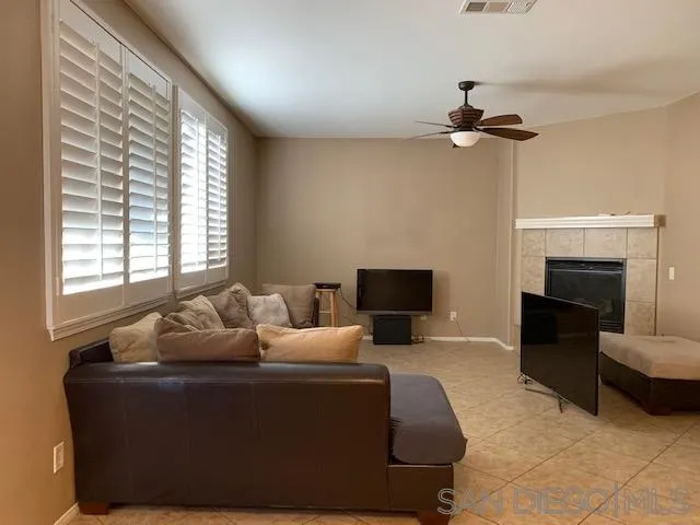 38325 Encanto Road Murrieta, CA 92563 - Photo 6 of 17 a living room with furniture and a fireplace