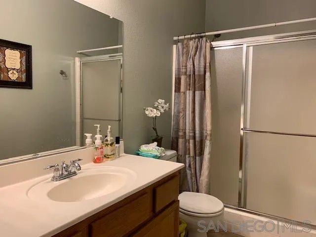 38325 Encanto Road Murrieta, CA 92563 - Photo 9 of 17 a bathroom with a sink toilet and shower