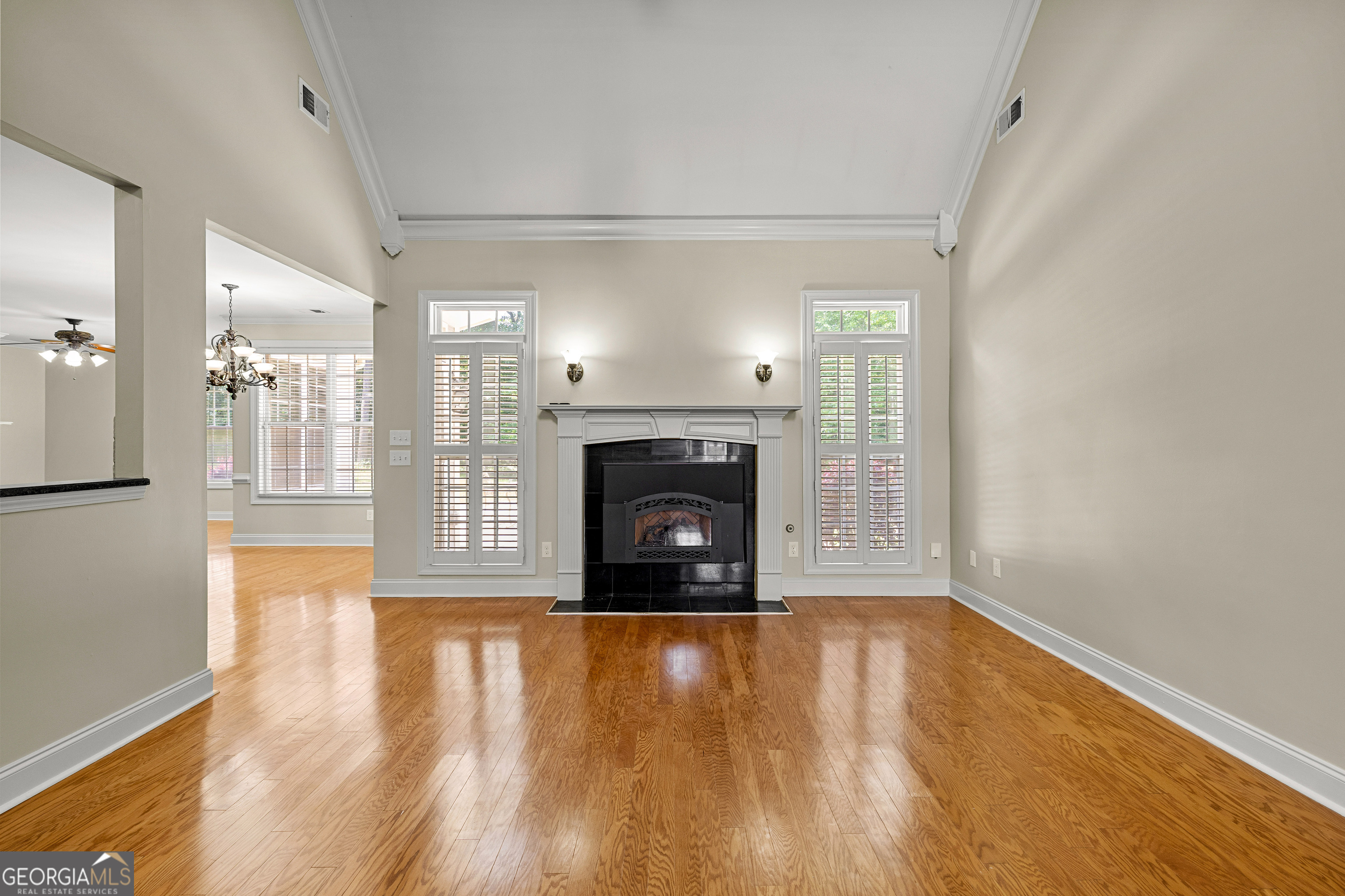 120 Shankhill Ridge Tyrone, GA 30290 - Photo 13 of 53 a view of an empty room with wooden floor a fireplace and a window