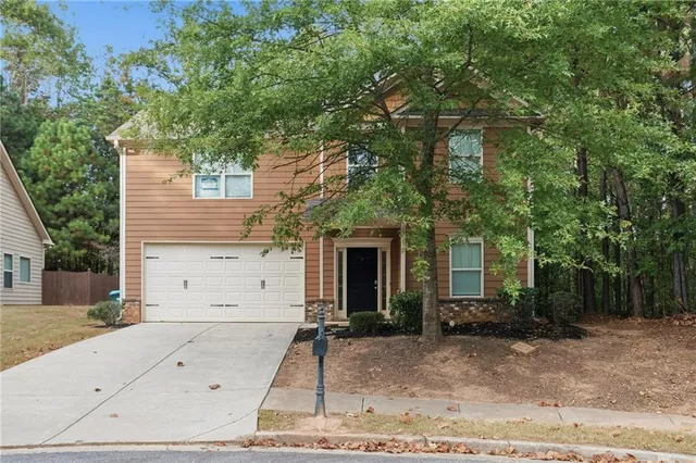 a view of a house with a tree