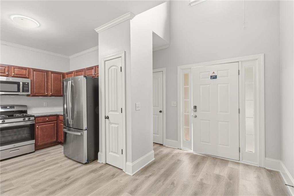 199 Mount Moriah Road Ball Ground, GA 30107 - Photo 11 of 39 a kitchen with stainless steel appliances granite countertop a refrigerator and a stove top oven