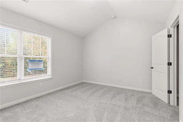 a bedroom with a bed potted plants and a flat screen tv