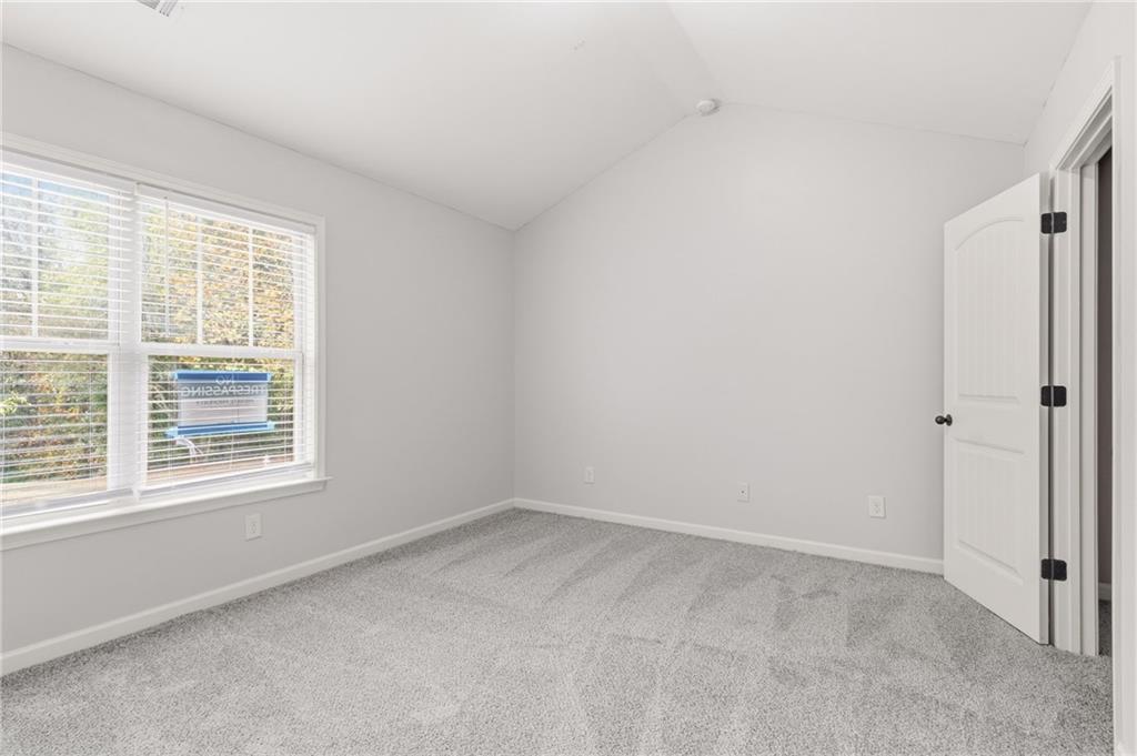 199 Mount Moriah Road Ball Ground, GA 30107 - Photo 17 of 39 a view of an empty room with a window