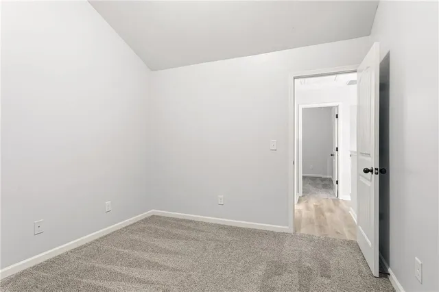 a bathroom with a granite countertop sink a toilet and a mirror