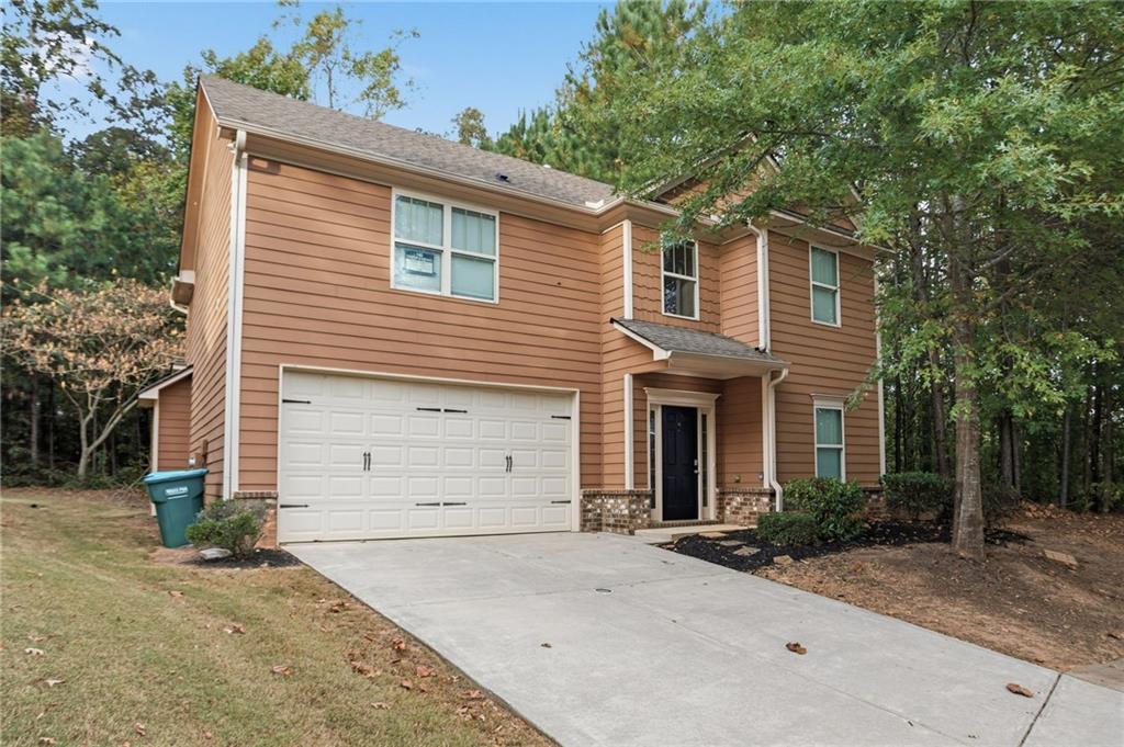 199 Mount Moriah Road Ball Ground, GA 30107 - Photo 2 of 39 a front view of a house with a yard and garage