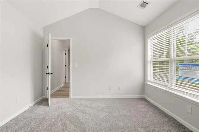 a view of a backyard with a small yard and large trees