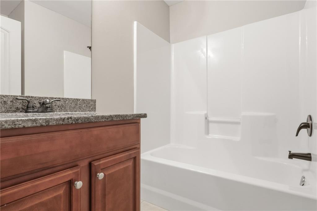 199 Mount Moriah Road Ball Ground, GA 30107 - Photo 30 of 39 a bathroom with a sink and a bathtub