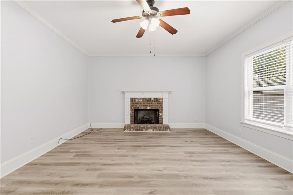 199 Mount Moriah Road Ball Ground, GA 30107 - Photo 4 of 39 a view of an empty room with a window and fireplace