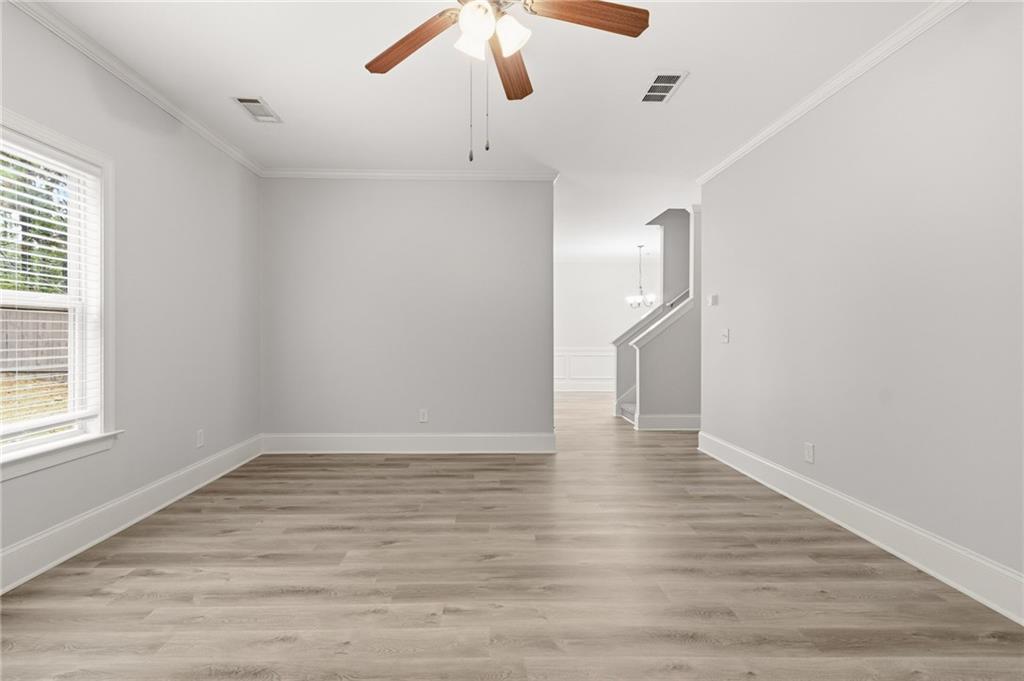 199 Mount Moriah Road Ball Ground, GA 30107 - Photo 7 of 39 a view of an empty room with wooden floor and a window