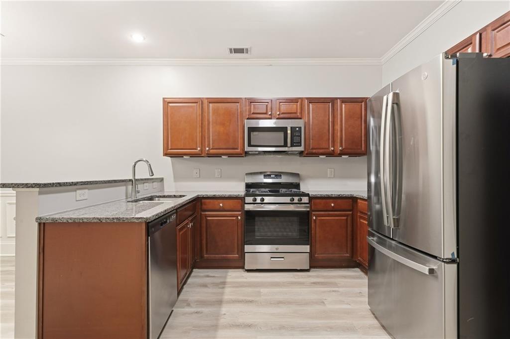 199 Mount Moriah Road Ball Ground, GA 30107 - Photo 9 of 39 a kitchen with stainless steel appliances granite countertop a refrigerator stove and sink