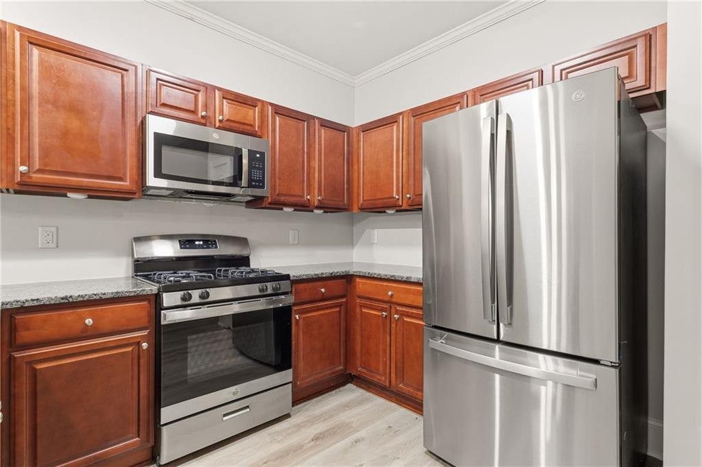 199 Mount Moriah Road Ball Ground, GA 30107 - Photo 10 of 39 a kitchen with stainless steel appliances granite countertop a refrigerator stove and microwave