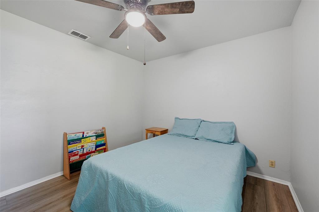 522 High Country Road Sherman, TX 75092 - Photo 20 of 38 a bedroom with a bed and wooden floor