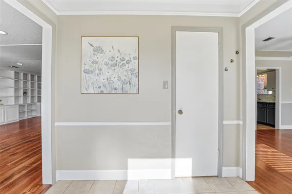 a view of entryway and hall with wooden floor