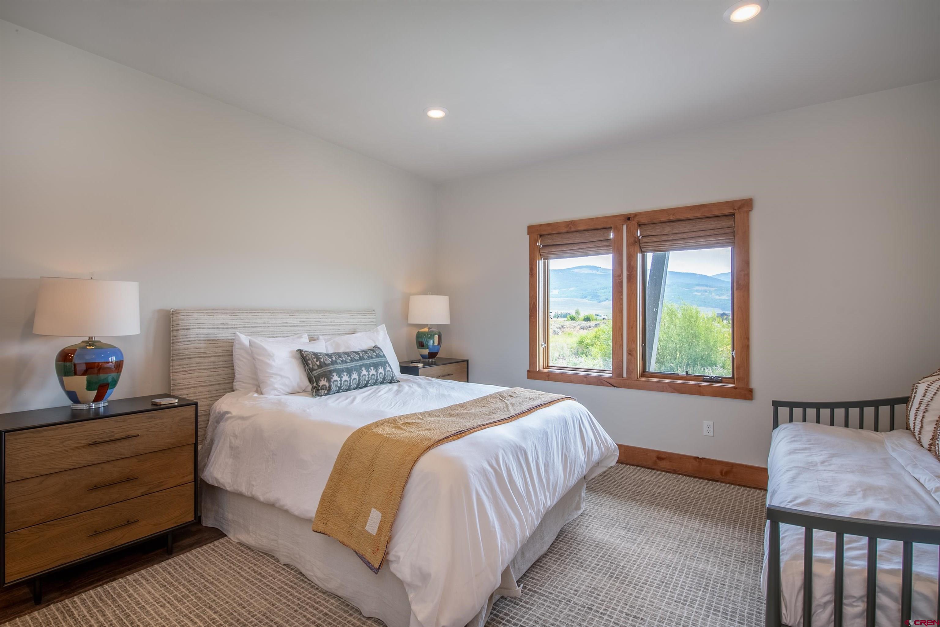 244 Elk Valley Road, Unit A Crested Butte, CO 81224 - Photo 21 of 35 a bedroom with a bed and a window