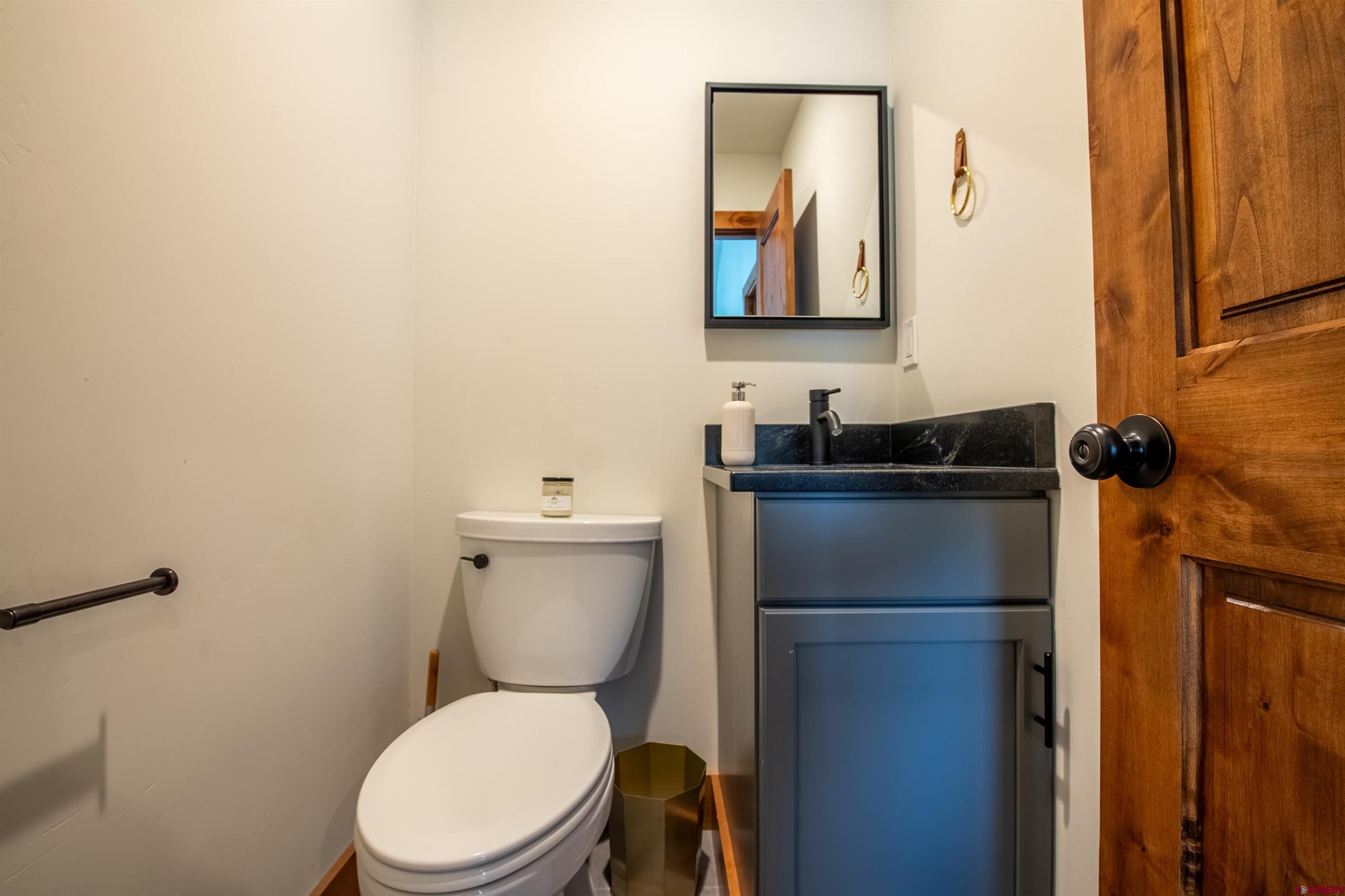 244 Elk Valley Road, Unit A Crested Butte, CO 81224 - Photo 24 of 35 a bathroom with a toilet sink and mirror