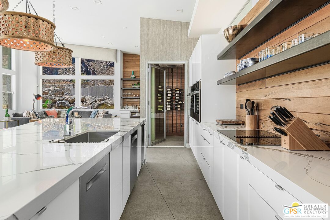 775 South La Mirada Road Palm Springs, CA 92264 - Photo 16 of 59 a large kitchen with stainless steel appliances granite countertop a sink and dishwasher next to a large window