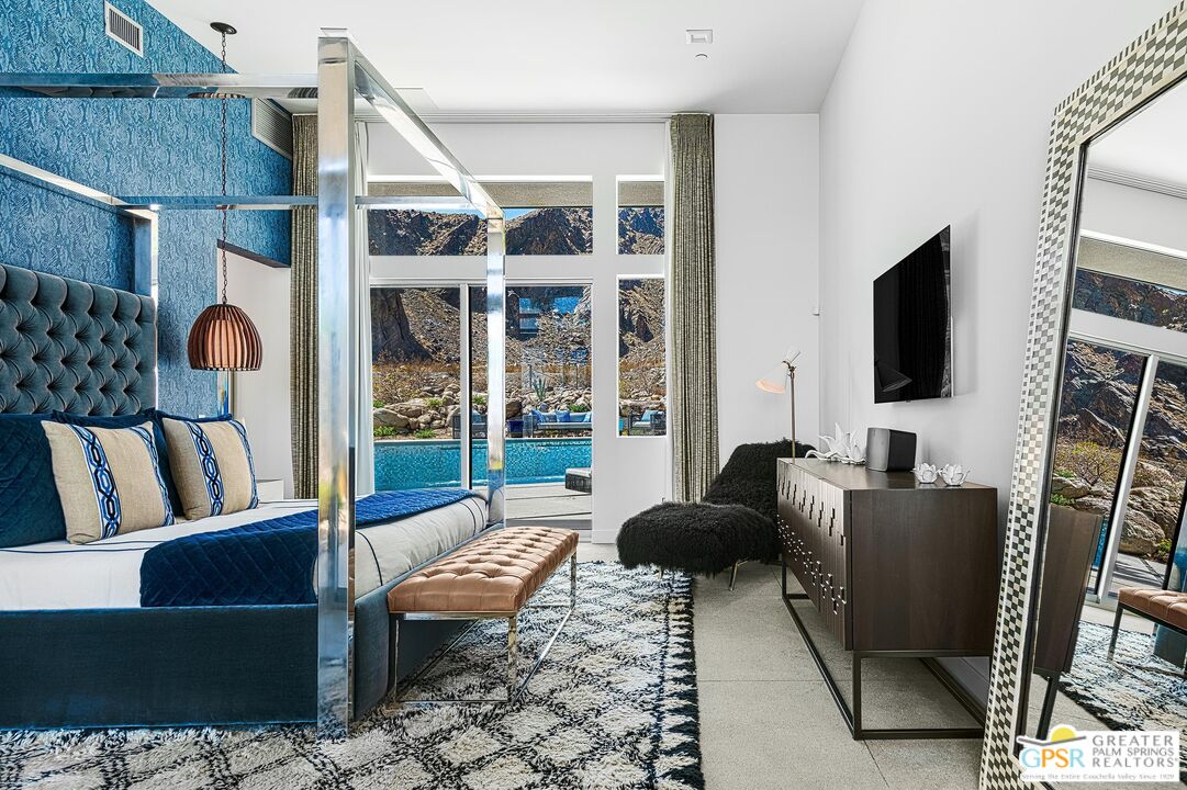 775 South La Mirada Road Palm Springs, CA 92264 - Photo 19 of 59 a living room with furniture a flat screen tv and a floor to ceiling window