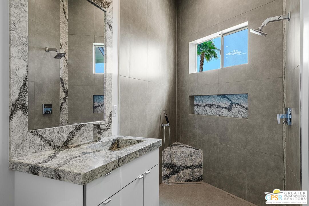 775 South La Mirada Road Palm Springs, CA 92264 - Photo 24 of 59 a en suite bathroom with a granite countertop sink a toilet and shower
