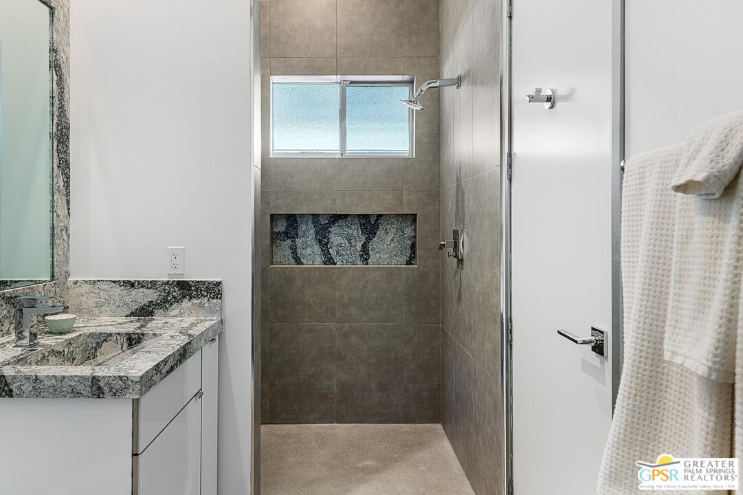 775 South La Mirada Road Palm Springs, CA 92264 - Photo 25 of 59 a bathroom with a granite countertop sink and a mirror