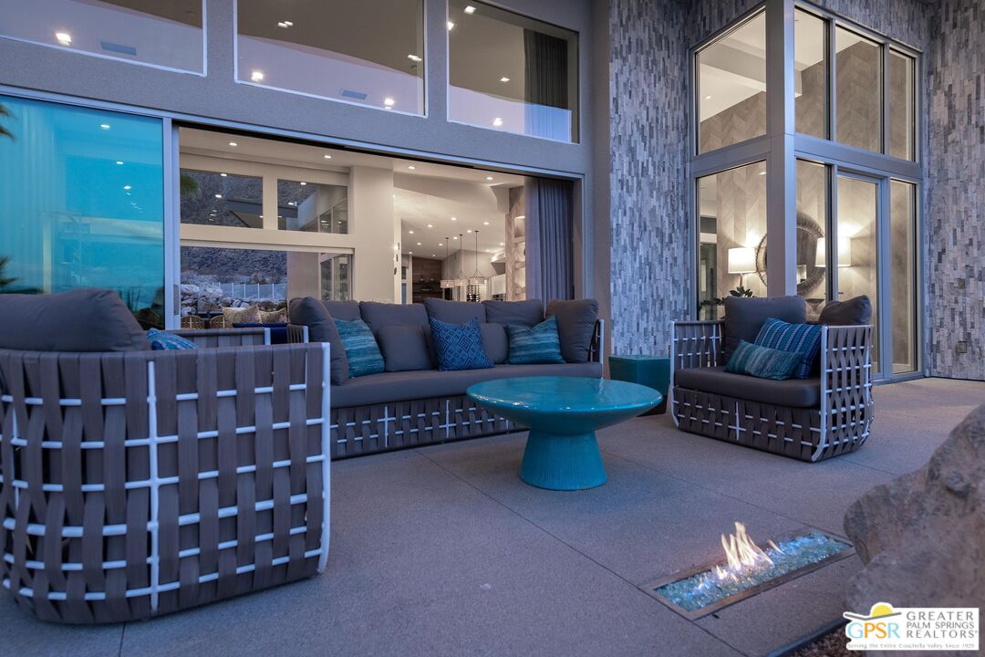 775 South La Mirada Road Palm Springs, CA 92264 - Photo 40 of 59 a living room with furniture a lamp and a fireplace