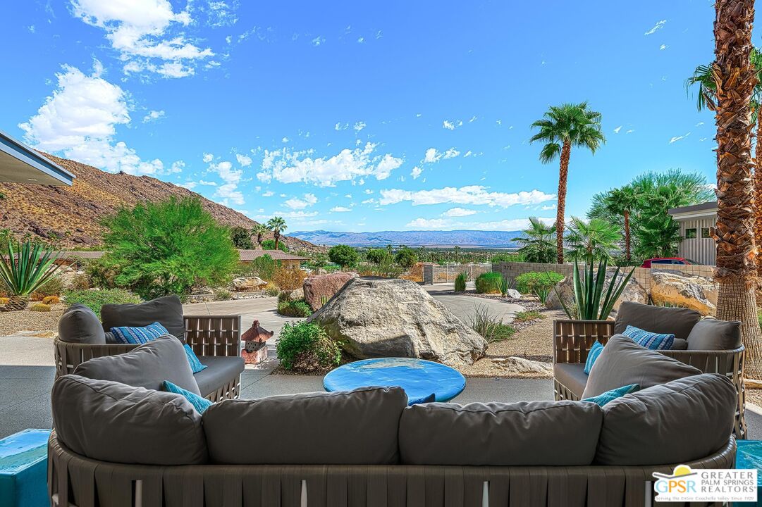 775 South La Mirada Road Palm Springs, CA 92264 - Photo 5 of 59 a view of a patio with couches table and chairs and potted plants