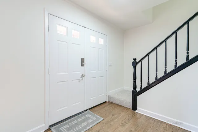 a view of an entryway with wooden floor