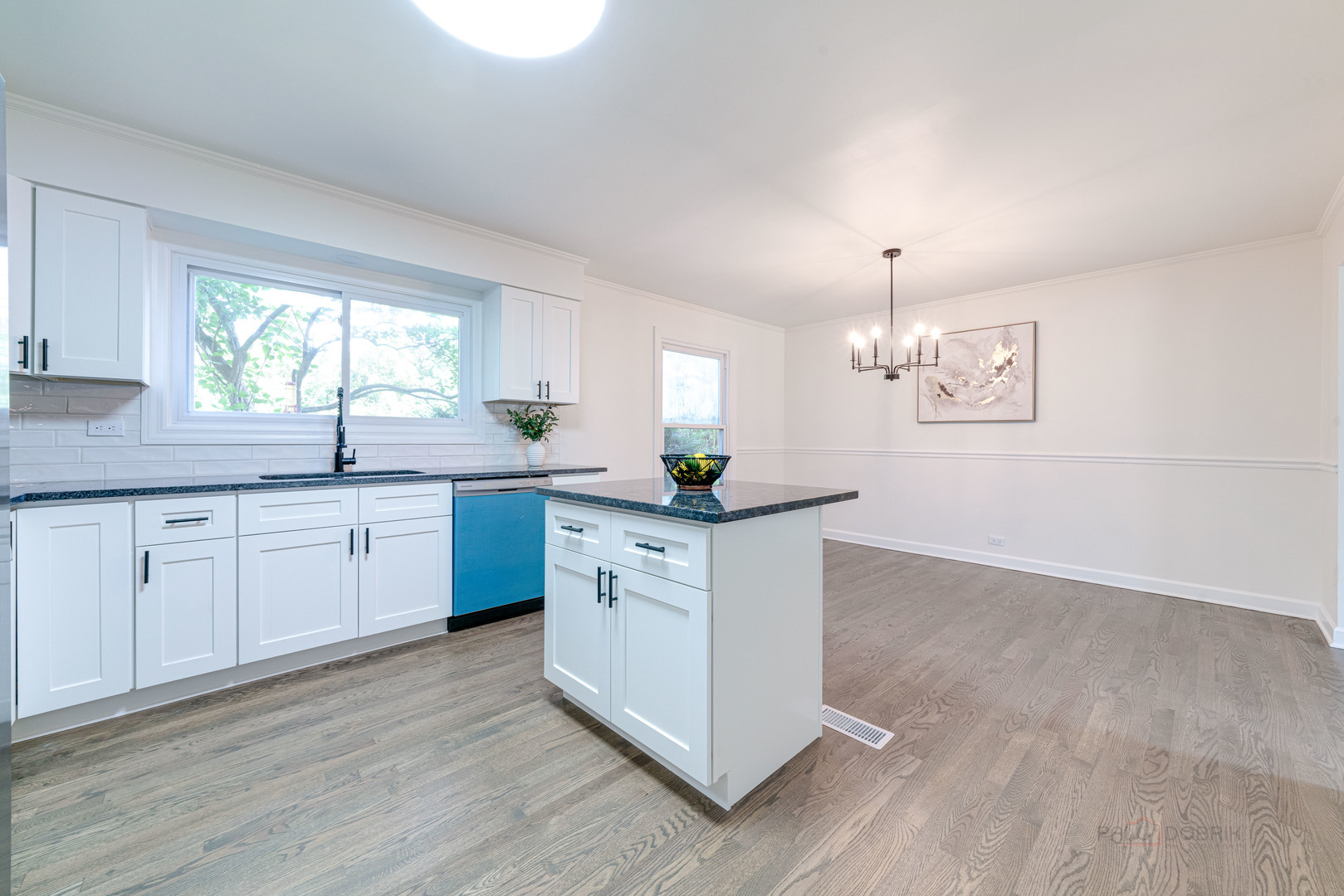 887 Saybrook Lane Buffalo Grove, IL 60089 - Photo 10 of 28 a kitchen with stainless steel appliances granite countertop a sink a stove and white cabinets with wooden floor