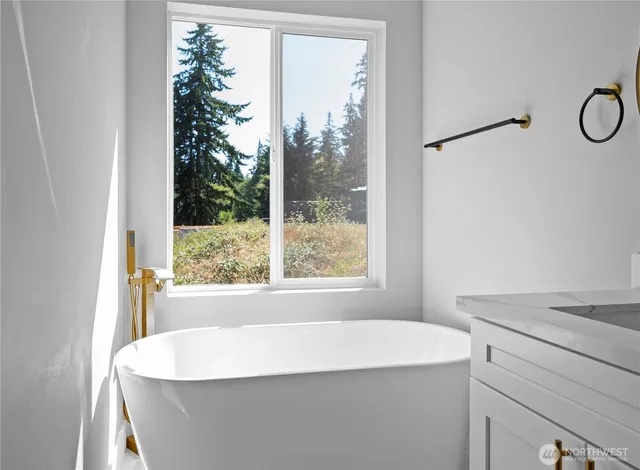 a bathroom with a toilet a sink a mirror and a bathtub