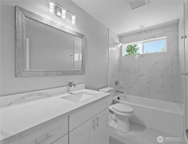 a living room with furniture wooden floor and a fireplace