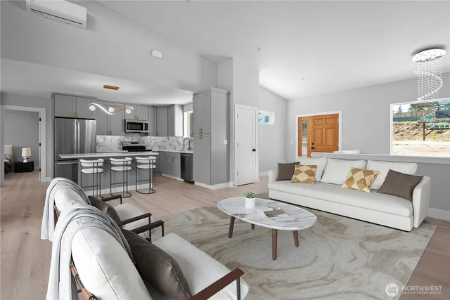 a living room with furniture and view of kitchen