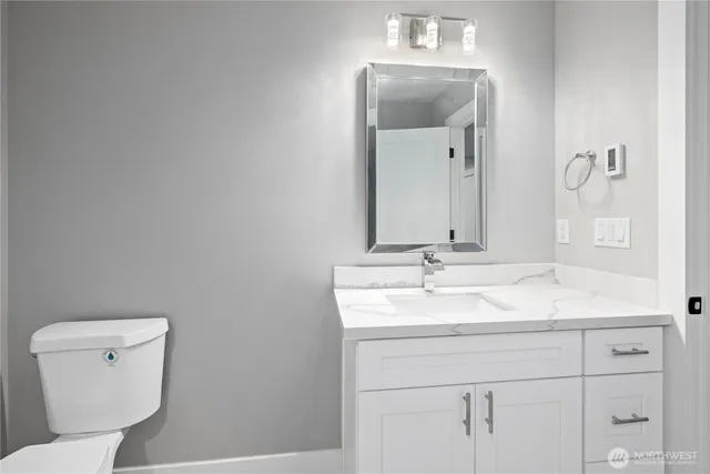 a kitchen with granite countertop white cabinets and sink