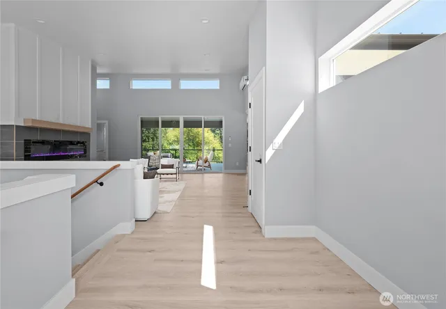 a view of a room that has a bed and a table in it