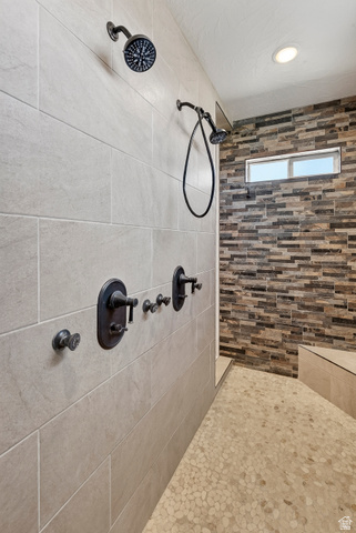 3311 West Allard Summit, UT 84772 - Photo 42 of 97 Walk-in shower featuring dual shower heads, dark bronze fixtures, and a horizontal rectangular window