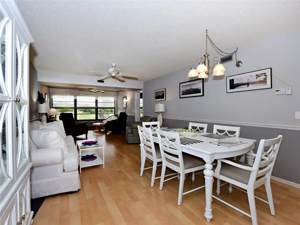 a view of a dining room with furniture and wooden floor
