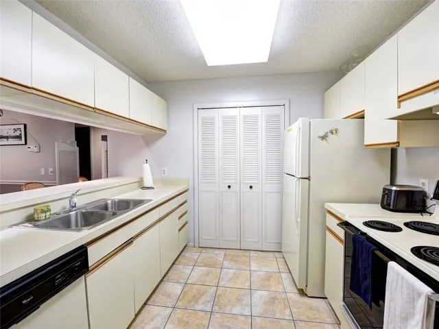a kitchen with a sink and a refrigerator