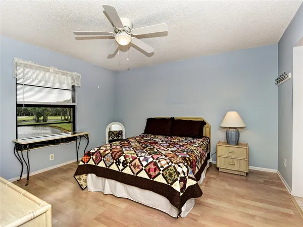a bedroom with a bed a dresser and chair