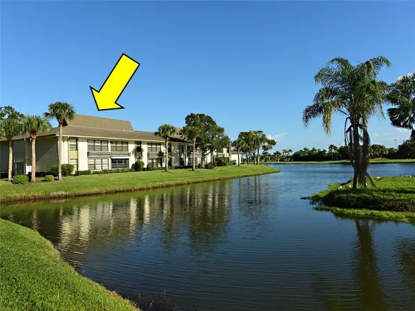 a view of a lake with a house in the background