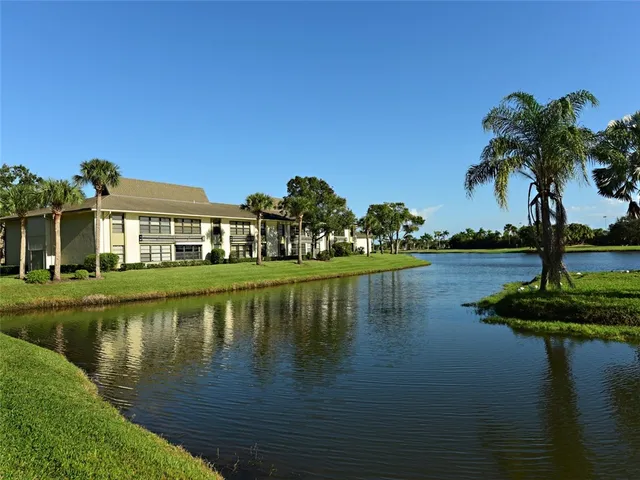a view of lake with a house in the background