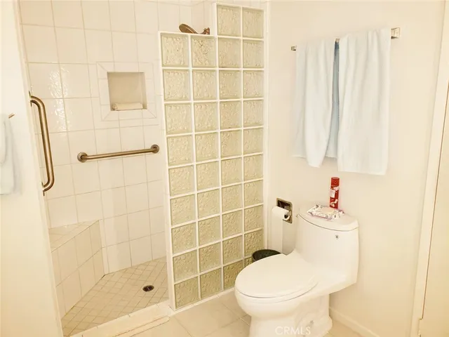 a white toilet sitting next to a bathroom sink
