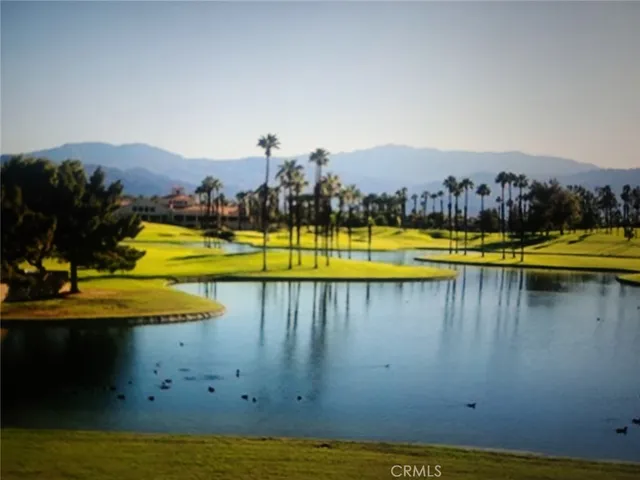 a kitchen with granite countertop a stove a microwave a sink and a refrigerator