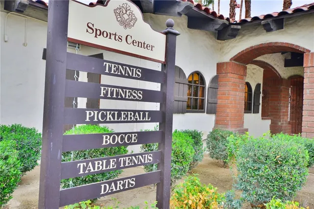 a view of a patio with a table and chairs and potted plants